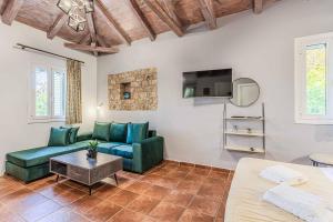 a living room with a couch and a table at Villa Palataki II in Kardamyli