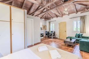 a living room with a couch and a table at Villa Palataki II in Kardamyli +20 photos