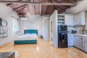 a kitchen and a bedroom with a bed in a room at Villa Palataki I in Kardamyli