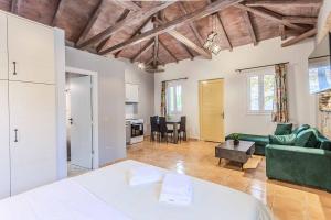 a room with a bed and a living room at Villa Palataki I in Kardamyli