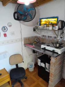 a kitchen with a desk and a chair in a room at Elvira's natural lodge in Burzaco