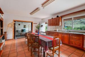 a kitchen with a table and wooden cabinets and a table and chairs at El Sueño de Mamá in Tegueste +40 photos