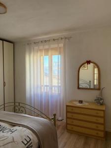 a bedroom with a bed and a mirror and a dresser at Casa Marta in Lisignago