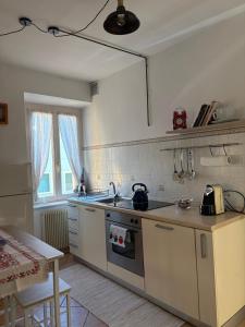 a kitchen with a sink and a stove top oven at Casa Marta in Lisignago