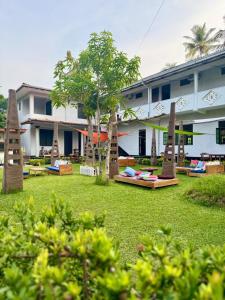 a hotel with a lawn in front of a building at Rock Hill Hotel in Galle