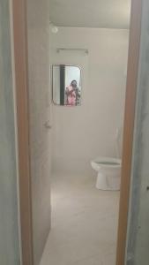 a bathroom with a mirror and a toilet at Vitthala rukmini in Gokarna