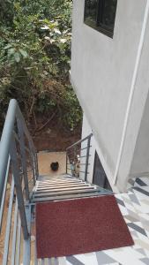 a stairway with a red rug next to a stair case at Vitthala rukmini in Gokarna