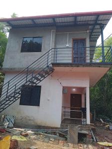 a house with a staircase in front of it at Vitthala rukmini in Gokarna