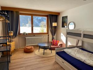 a bedroom with a bed and a table and a chair at Whiteberg Apartment in Schruns