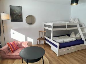 a living room with a bunk bed and a table at Whiteberg Apartment in Schruns +35 photos
