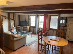 a living room with a couch and a table at Maison de caractère in Les Bordes-sur-Arize