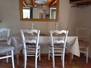 a dining room table with two chairs and a mirror at La Maisonnette - animaux acceptés, parking privé, jardin plein sud in Wissant +16 photos