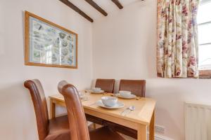 a dining room table with chairs and a wooden table at 2 Bed in Wangford oc-8hsw in Wangford +6 photos