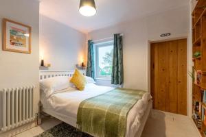 a bedroom with a bed and a window at 3 Bed in Kessingland oc-b27635 in Kessingland