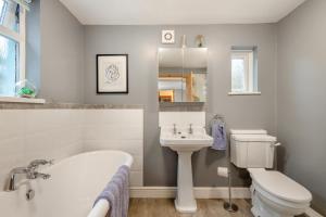 a bathroom with a tub and a toilet and a sink at 3 Bed in Kessingland oc-b27635 in Kessingland +19 photos
