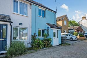 a blue house with a car parked in a driveway at 3 Bed in Kessingland oc-b27635 in Kessingland