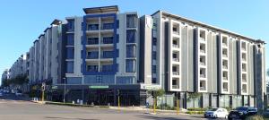a large building on the corner of a street at Umhlanga Apart Hotel in Durban