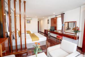 a hotel room with a bed and a desk at Catinal Hotel in Danang
