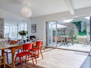 a dining room with a table and chairs and a glass door at 4 Bed in Bridport oc-dc083 in West Bay