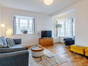 a living room with a couch and a tv at 4 Bed in Bridport oc-dc083 in West Bay