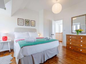 a bedroom with a large bed with towels on it at 4 Bed in Bridport oc-dc083 in West Bay