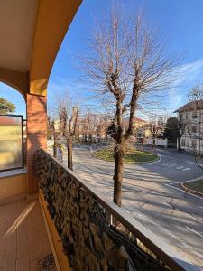 a balcony with a tree on a street at Casa San Martino 21 in Uboldo