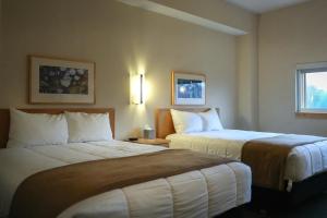 a hotel room with two beds in a room at Prince Conference Center & Hotel in Grand Rapids