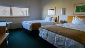a hotel room with two beds and a window at Prince Conference Center & Hotel in Grand Rapids