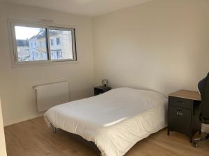 a small bedroom with a bed and a window at Cozy M&O House in Le Mans