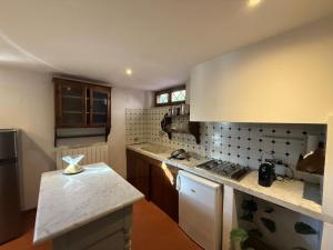 a kitchen with a stove and a counter top at Joe's apartments in Carrara