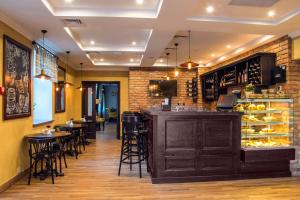 a bar in a restaurant with tables and chairs at Premier Hotel Pochaiv in Pochayiv