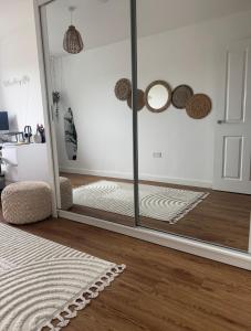 a room with a glass door and a mirror at 2 Bed apartment- Laindon in Great Burstead