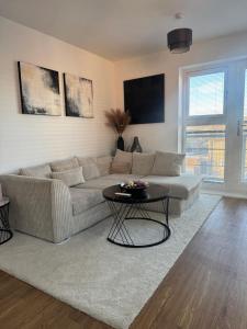 a living room with a couch and a table at 2 Bed apartment- Laindon in Great Burstead