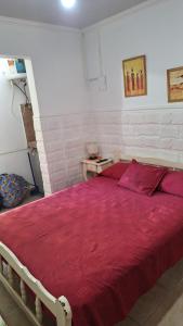 a bedroom with a red bed with a red blanket at MONOAMBIENTE Flores del Cielo in Federación