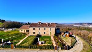 an old house on a hill with a yard at Sangi Chianti Vacations in Poggibonsi