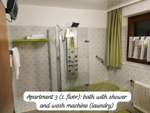 a bathroom with a shower with a tub and a sink at Angi's Apartment in Sankt Lorenzen ob Murau +25 photos