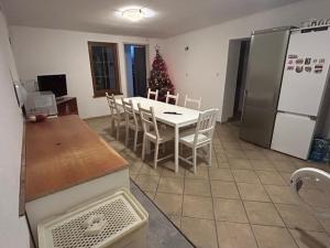 a kitchen with a table and chairs and a christmas tree at Kwatery Mamma Mia Opawska 1a in Krzanowice +6 photos