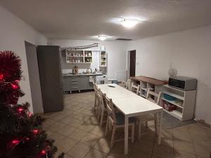 a kitchen with a table and a christmas tree in it at Kwatery Mamma Mia Opawska 1a in Krzanowice
