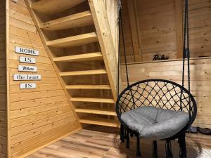 a swinging chair in a room with stairs at Cottage Soul Rest in Visoko