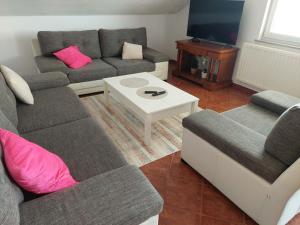 a living room with a couch and a table at Apartmani Ivan in Kupres