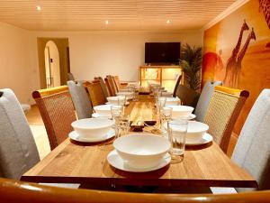a long table with white plates and glasses on it at Townhaus Mariaroth in Dieblich