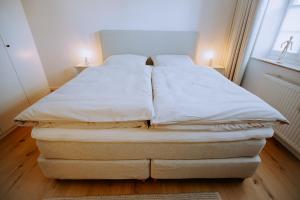 a bed in a room with two pillows on it at Emsperle in Rietberg