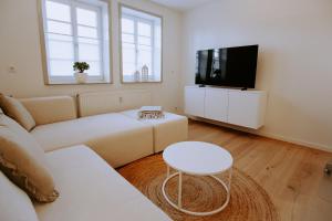 a living room with a couch and a tv at Emsperle in Rietberg