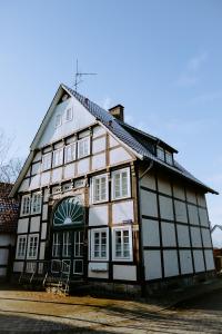 a black and white building with windows on a street at Emsperle in Rietberg