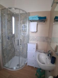 a bathroom with a shower and a sink at Posidonia in Lizzano