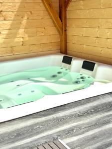 a jacuzzi tub in a wooden cabin at La Clé de L Insolite in Hudiviller +25 photos
