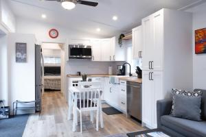 a kitchen with white cabinets and a table in a room at Cozy 2 Bedroom Cabin in Sunshine Valley