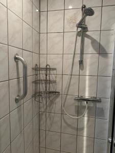 a shower with a hose in a bathroom at Hyggehuset in Tønder +13 photos
