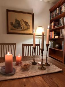 a table with three candles and a bowl of food on it at Hyggehuset in Tønder