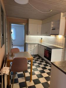 a kitchen with a table and two chairs and a table at Hyggehuset in Tønder
